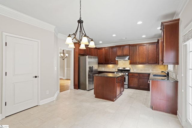 kitchen featuring pendant lighting, appliances with stainless steel finishes, a kitchen island, sink, and crown molding