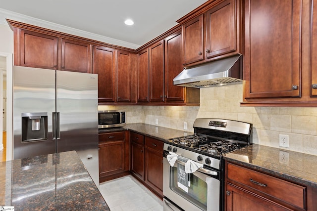 kitchen featuring decorative backsplash, appliances with stainless steel finishes, dark stone counters, and crown molding