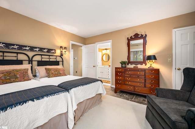 bedroom with ensuite bath and carpet