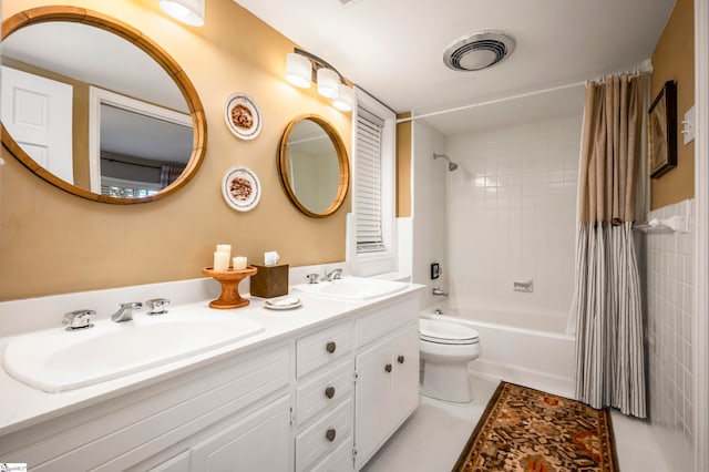 full bathroom with vanity, shower / bath combo, toilet, and tile patterned floors