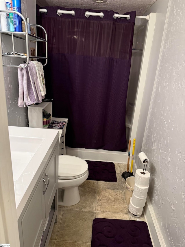 full bathroom featuring tile patterned floors, shower / bath combo, toilet, vanity, and a textured ceiling