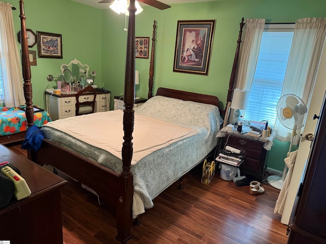 bedroom with multiple windows, ceiling fan, and dark hardwood / wood-style flooring