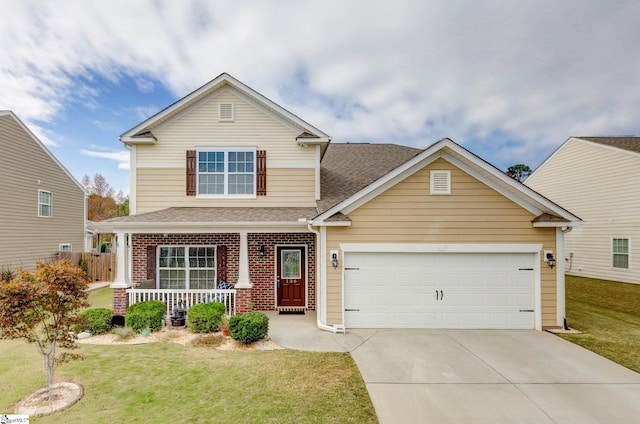 view of front of home with a porch, a front lawn, and a garage