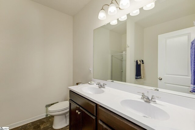 bathroom featuring toilet, walk in shower, and vanity