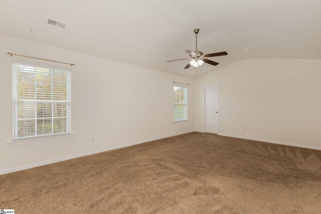 carpeted empty room with lofted ceiling and ceiling fan