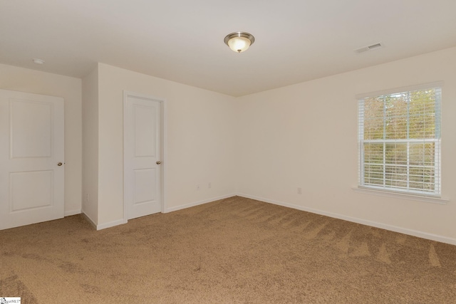 spare room featuring carpet