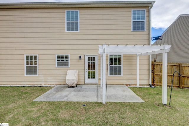 back of property with a patio area, a lawn, and a pergola