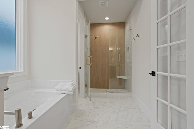 bathroom featuring shower with separate bathtub