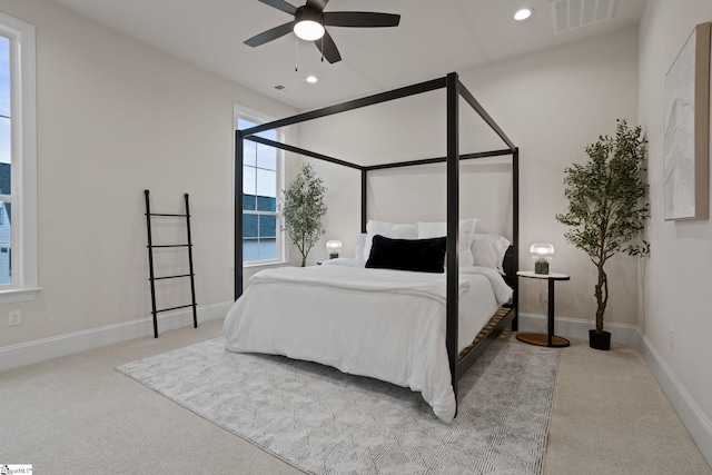 bedroom with ceiling fan and light carpet