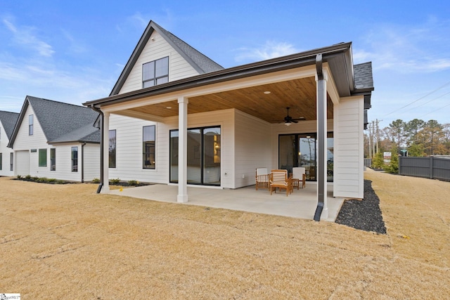 rear view of house with a lawn, ceiling fan, and a patio area