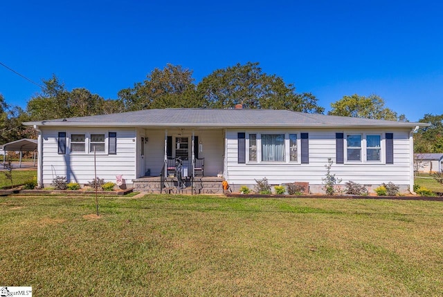 ranch-style home featuring a carport and a front yard