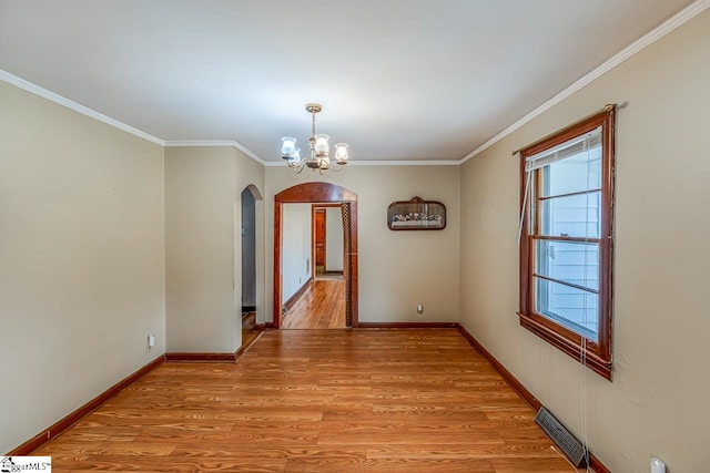 unfurnished dining area with ornamental molding, light hardwood / wood-style flooring, and a chandelier