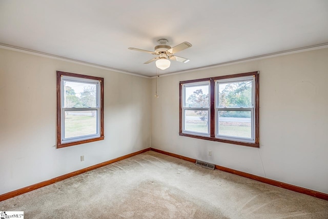 carpeted empty room featuring crown molding and ceiling fan