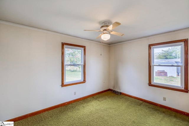 empty room with crown molding, carpet flooring, and ceiling fan