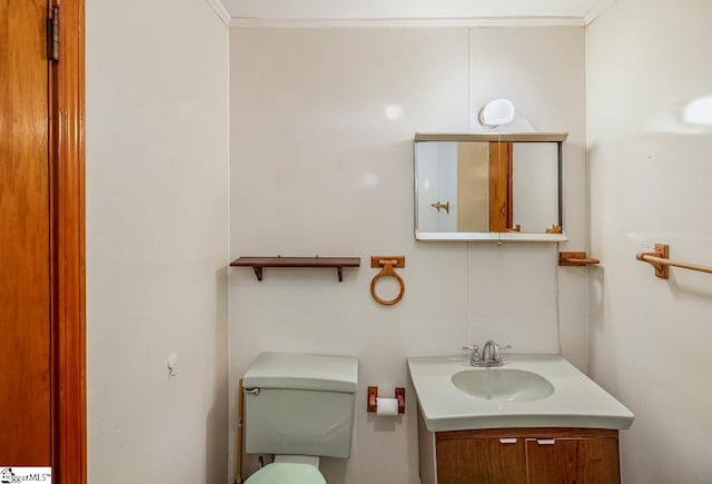 bathroom featuring vanity, toilet, and crown molding