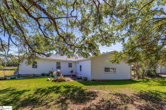 back of property featuring a lawn