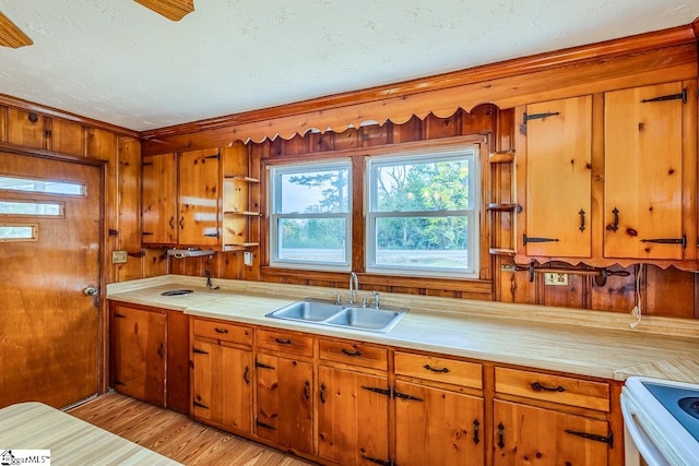 kitchen featuring light hardwood / wood-style flooring, white electric range oven, sink, and a textured ceiling