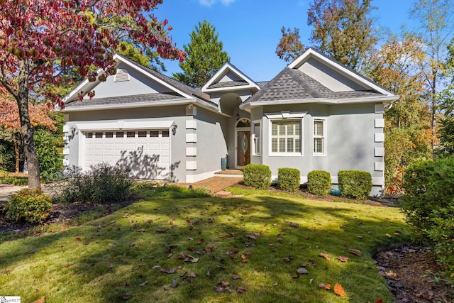 view of front of home featuring a front lawn and a garage