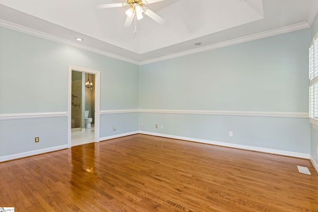 empty room featuring ceiling fan, ornamental molding, and hardwood / wood-style floors