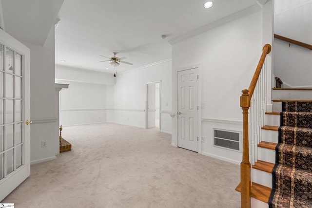 interior space featuring crown molding, light colored carpet, and ceiling fan