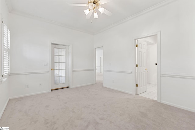 carpeted spare room featuring ornamental molding and ceiling fan