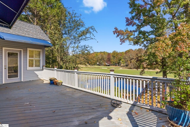 wooden terrace featuring a lawn