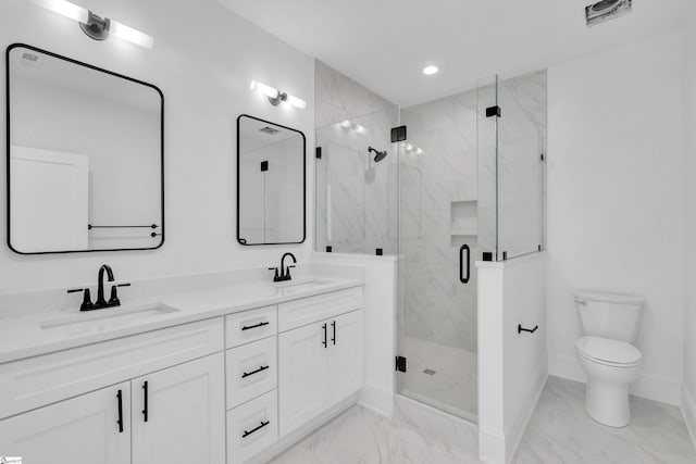 bathroom featuring vanity, toilet, and a shower with shower door