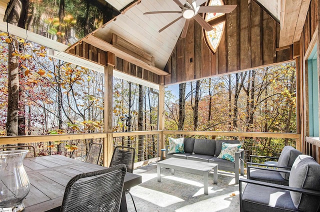 sunroom with ceiling fan, a healthy amount of sunlight, and vaulted ceiling