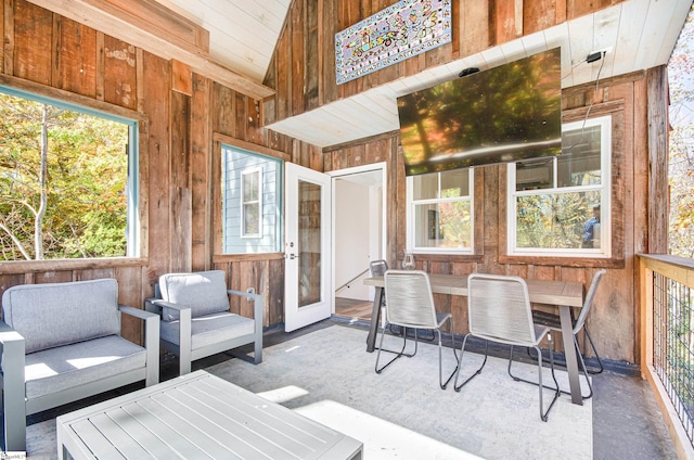 sunroom / solarium with a healthy amount of sunlight and vaulted ceiling