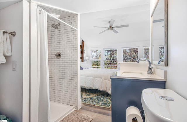 bathroom featuring vanity, curtained shower, wood-type flooring, and ceiling fan