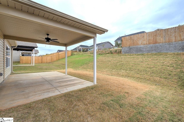 view of yard with a patio area and ceiling fan