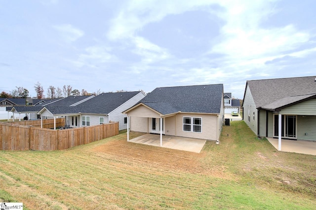 back of house featuring a yard and a patio area