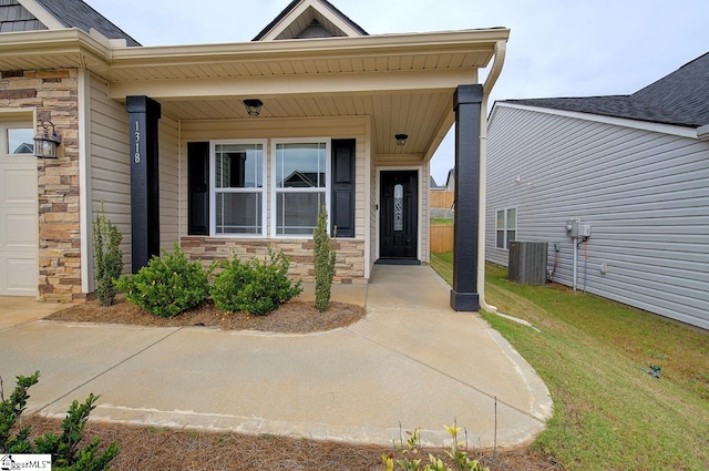 doorway to property with covered porch, cooling unit, and a lawn