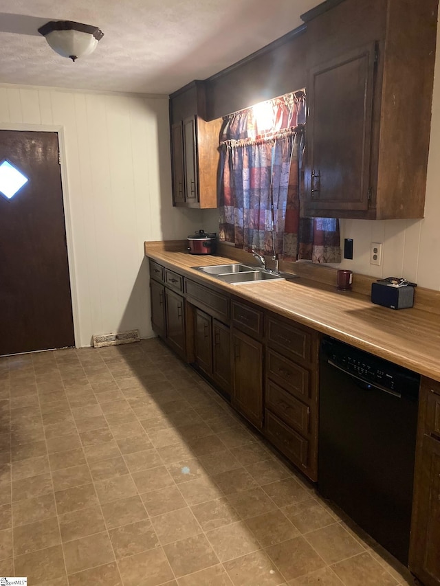 kitchen featuring dishwasher, dark brown cabinets, and sink