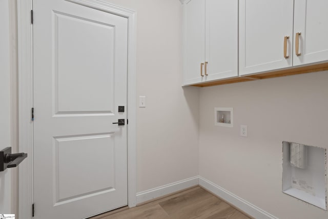 laundry room with washer hookup, cabinets, and light hardwood / wood-style flooring