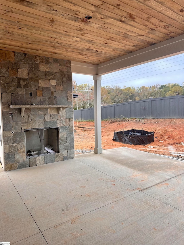 view of patio with an outdoor stone fireplace