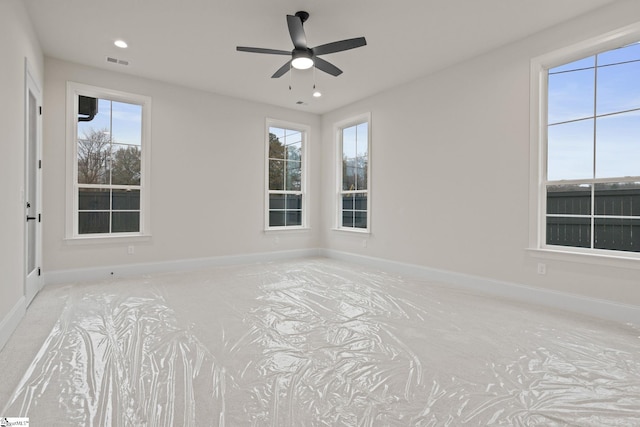 empty room with a wealth of natural light and ceiling fan