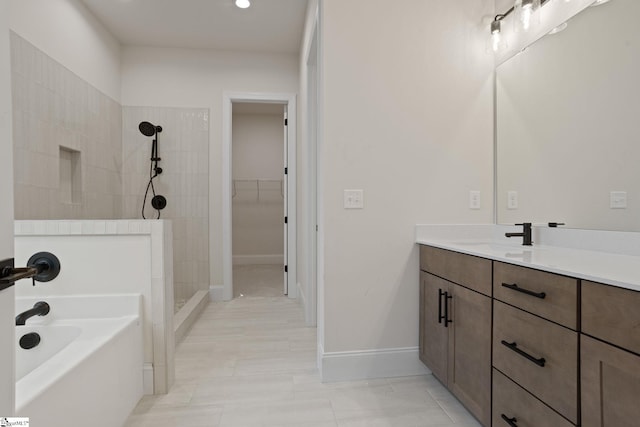 bathroom featuring tile patterned flooring, vanity, and shower with separate bathtub