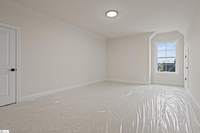 bonus room featuring light colored carpet and lofted ceiling