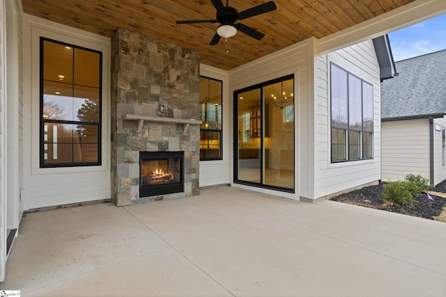 view of patio / terrace featuring an outdoor stone fireplace and ceiling fan