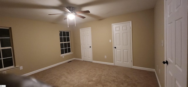 unfurnished bedroom featuring ceiling fan and light colored carpet