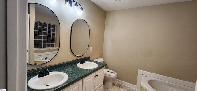 bathroom featuring toilet, a washtub, and vanity