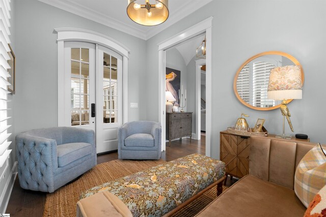 living area with french doors, dark hardwood / wood-style floors, and crown molding