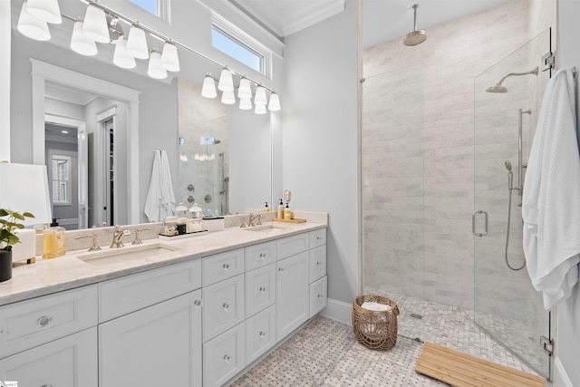 bathroom featuring tile patterned floors, vanity, a shower with door, and ornamental molding