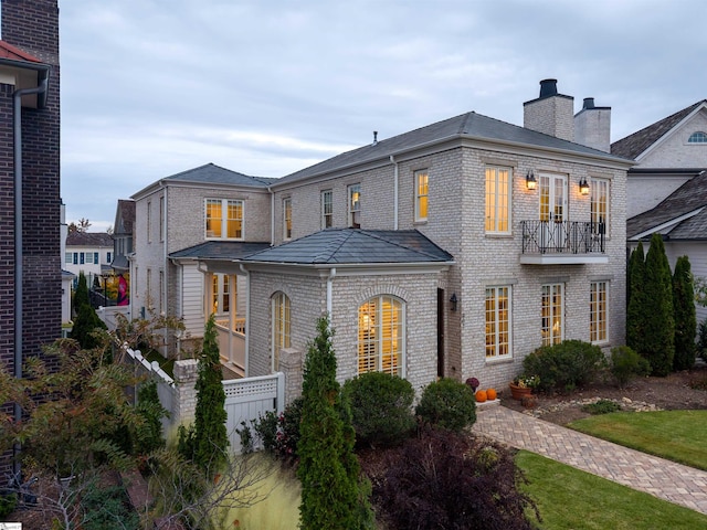 view of front of house featuring a balcony