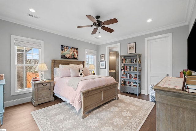 bedroom with ornamental molding, light wood-type flooring, multiple windows, and ceiling fan