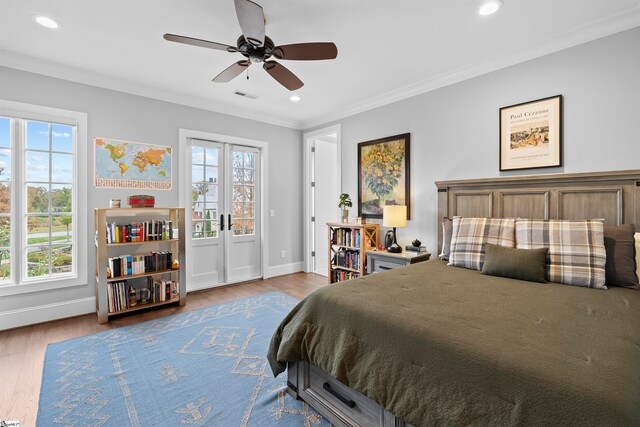 bedroom with light wood-type flooring, ceiling fan, and crown molding