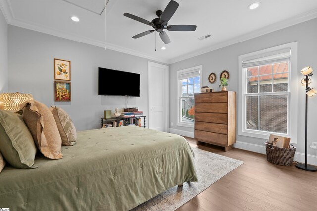 bedroom featuring hardwood / wood-style floors, ceiling fan, and crown molding