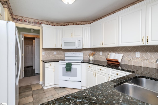 kitchen with sink, white cabinetry, white appliances, and light tile patterned floors