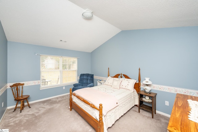 carpeted bedroom with vaulted ceiling and a textured ceiling